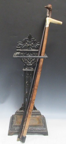 Lot 819 - Cast iron stick stand, plus sticks