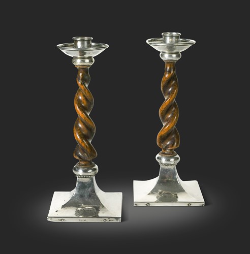 Lot 165 - A pair of Arts & Crafts barley twist oak and silver mounted candlesticks, mark of A.E. Jones