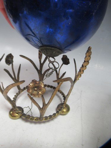 Lot 14 - Blue glass witches ball on gilt metal stand...