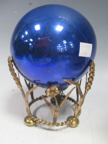 Lot 14 - Blue glass witches ball on gilt metal stand...