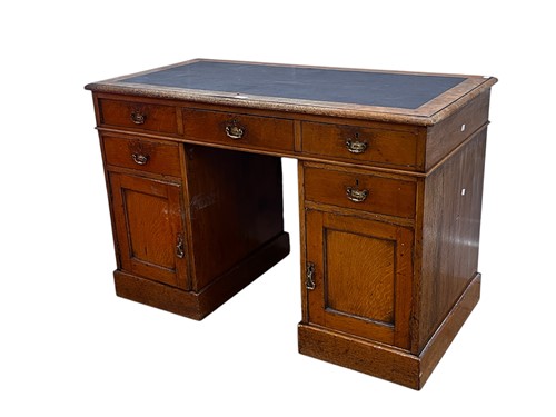 Lot 745 - An Edwardian oak twin pedestal desk, with...