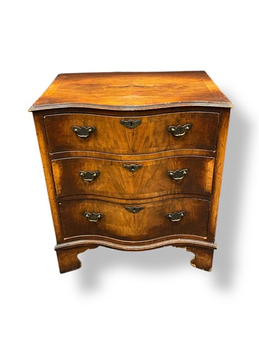 Lot 608 - A 1930's walnut serpentine chest of three...