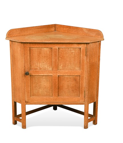 Lot 203 - A Heal's limed oak floor standing corner cupboard, circa 1920