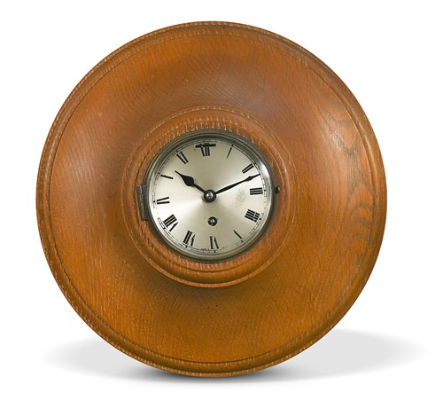 Lot 134 - A limed Oak circular wall clock retailed by Heal's, circa 1930