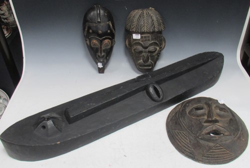 Lot 175 - Three African tribal carved wood face masks, a...
