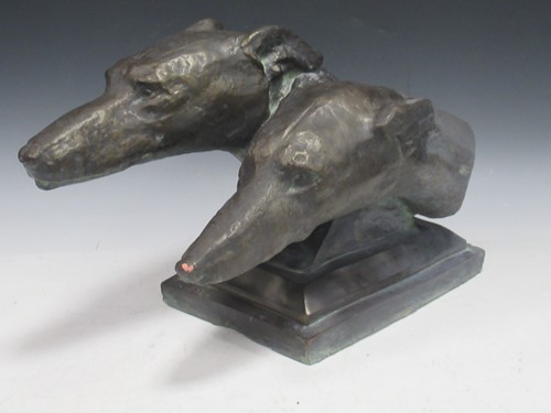 Lot 54 - A bronzed terracotta model of two whippets, 27...