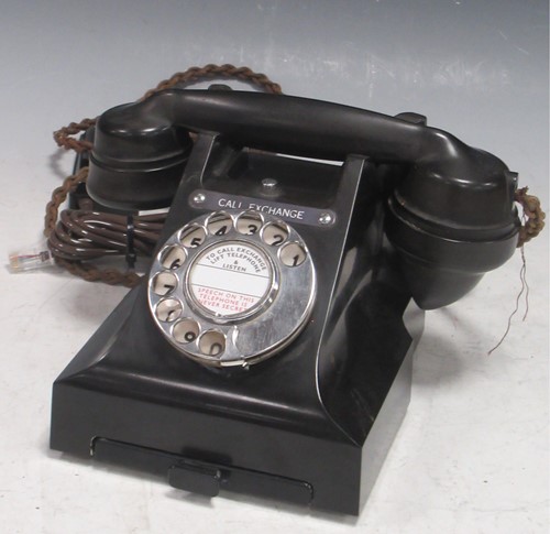 Lot 228 - An early 20th century black bakelite telephone,...