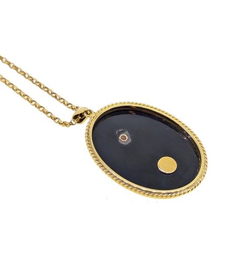 Lot 40 - An onyx, opal and ruby pendant and chain