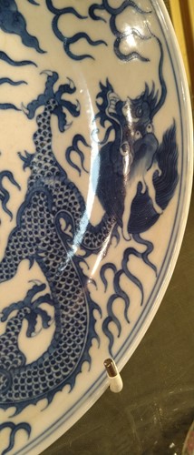 Lot 18 - A Chinese blue and white plate decorated with...