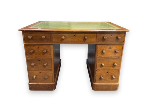 Lot 740 - A 20th century pedestal desk with green...