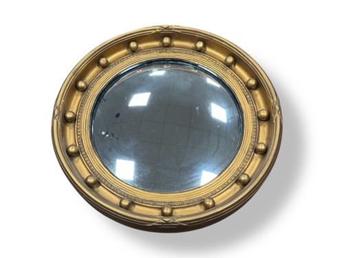 Lot 728 - A Regency style convex wall mirror, the frame...