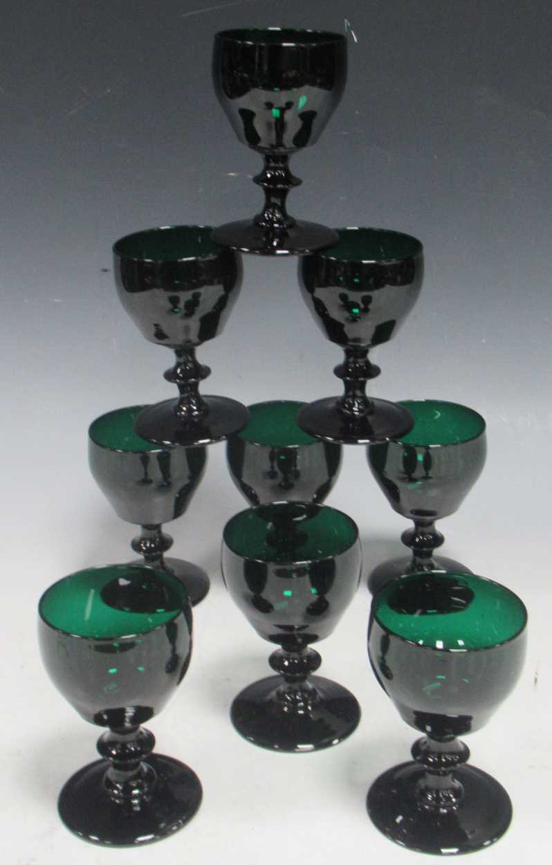 Lot 12 - A set of nine green glass wine glasses with...