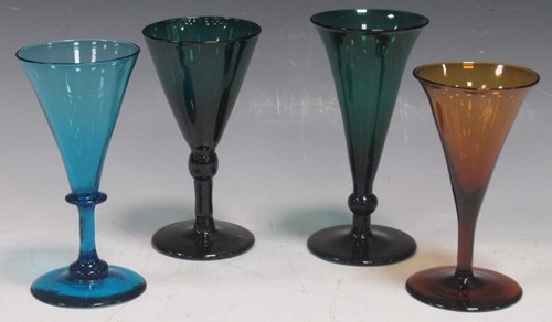 Lot 31 - A set of four green glass wine glasses, circa...
