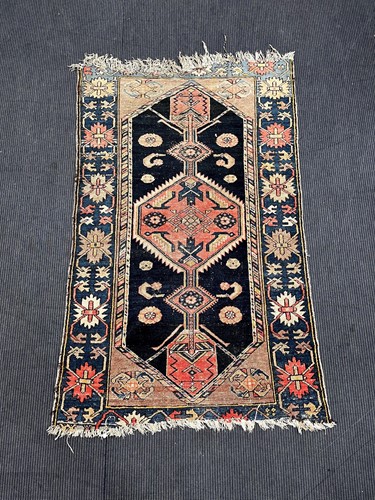 Lot 879 - A blue ground tribal rug, 183 x 109cm