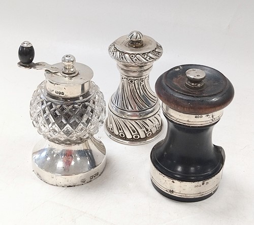 Lot 345 - A trio of silver pepper grinders; the first of...