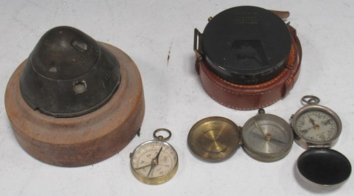 Lot 196 - Three cased compasses and a shell detonator