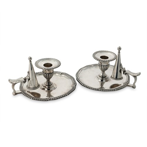 Lot 458 - A visual pair of George III silver chambersticks