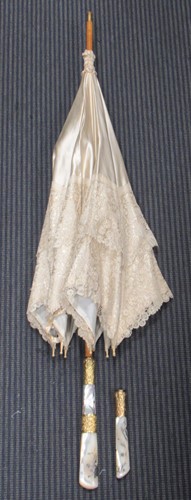 Lot 178 - A lace trimmed cream silk parasol with agate...