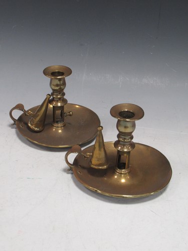 Lot 173 - A pair of brass ejector chambersticks, late...
