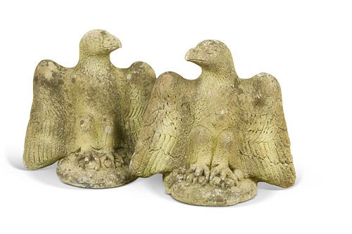 Lot 735 - An opposing pair of composite stone eagles, 20th century
