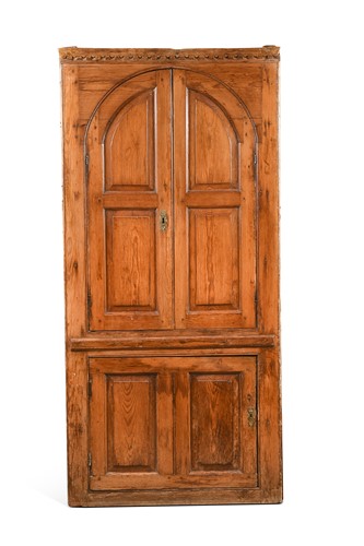 Lot 443 - A George III barrel back pine corner cupboard