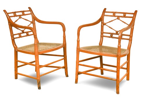 Lot 583 - A pair of Regency style faux-bamboo painted open armchairs
