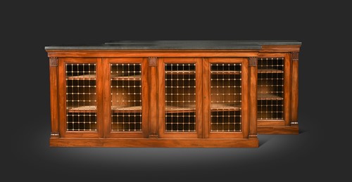 Lot 601 - A pair of George IV marble topped mahogany bookcases