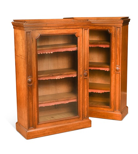Lot 567 - A pair of early Victorian fiddleback mahogany bookcase cabinets