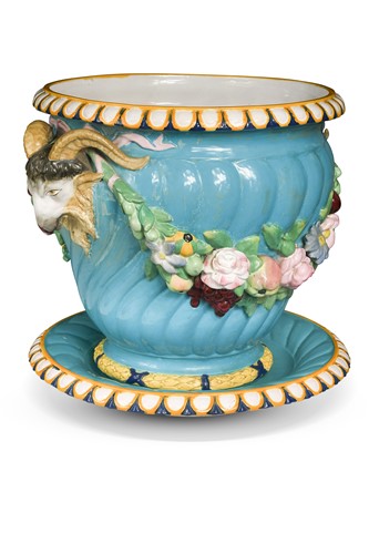 Lot 507 - A Victorian majolica pottery ram mask handled jardiniere on standish, circa 1880