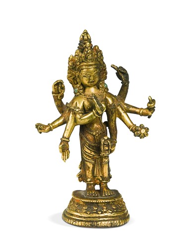 Lot 103 - A Tibetan gilt bronze small figure of the eight-armed Avalokiteshvara, late 19th/early 20th century