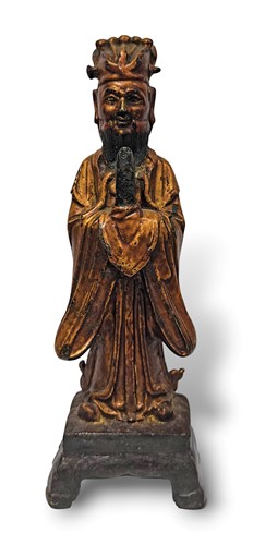 Lot 72 - A gilded iron standing official, late Ming Dynasty