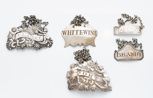 Lot 336 - An unusually heavy George III silver bottle label along with 4 others