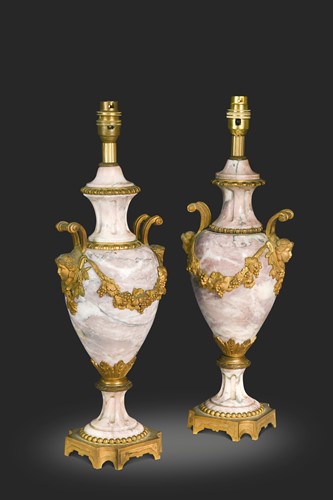 Lot 666 - A pair of pink marble and ormolu lamps, 19th century