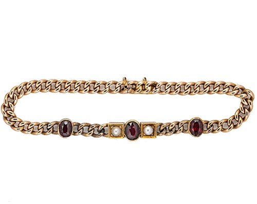 Lot 90 - An Edwardian garnet and split pearl bracelet
