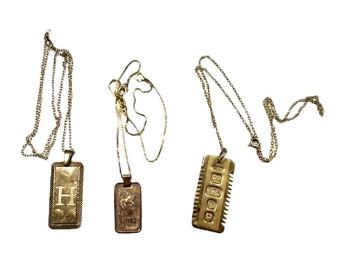 Lot 266 - Three ingot pendants and chains, either...