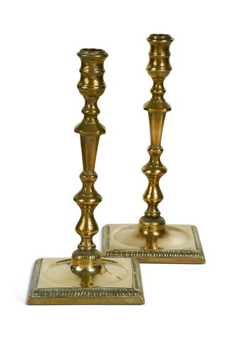 Lot 453 - A pair of George III style brass candlesticks