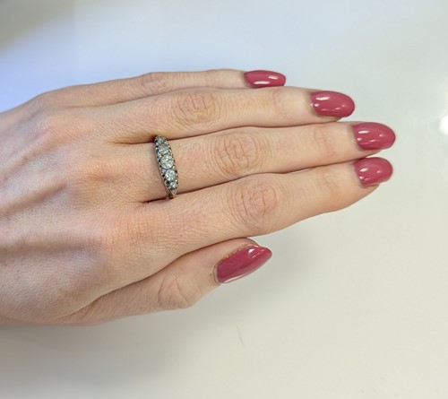 Lot 64 - A diamond set carved half hoop style ring