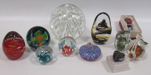 Lot 81 - A collection of glass paper weights to include...