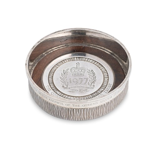 Lot 563 - An Elizabeth II silver bottle coaster of heavy gauge, mark of Gerald Benney