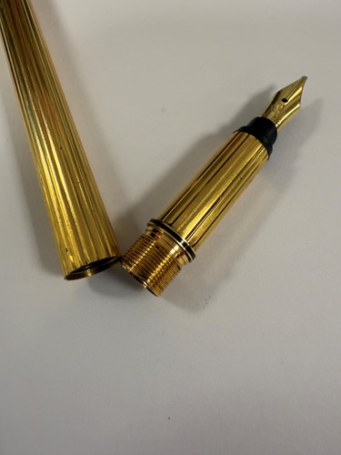 Lot 301 - Cartier - A 'Les Must De Cartier Trinity' fountain pen, together with a Tiffany letter opener