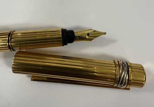 Lot 301 - Cartier - A 'Les Must De Cartier Trinity' fountain pen, together with a Tiffany letter opener