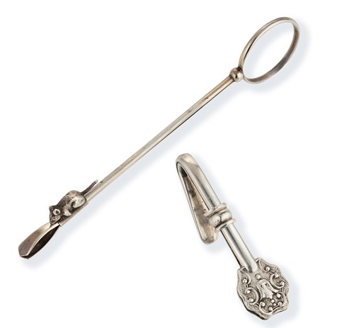 Lot 328 - A rare continental metalwares skirt lifter, together with a silver napkin clip