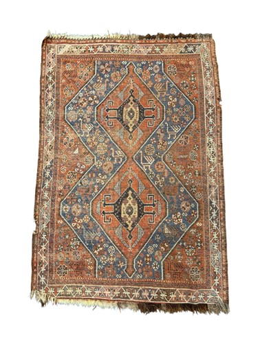 Lot 663 - A Caucasian rug with two lozenges on a red...
