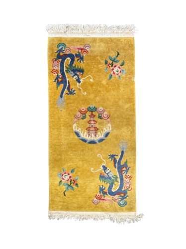 Lot 664 - A Chinese wool rug, yellow ground decorated...
