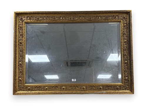 Lot 628 - A gilt framed rectangular wall mirror, the...