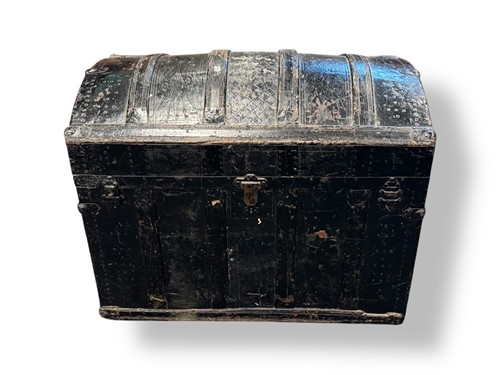 Lot 593 - A black painted dome topped trunk, with hinged...