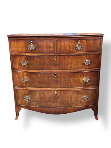 Lot 568 - A Regency bow front chest of two short and...