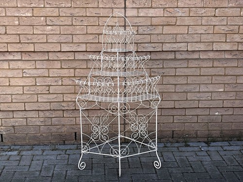 Lot 778 - A white painted wirework three tier plant...