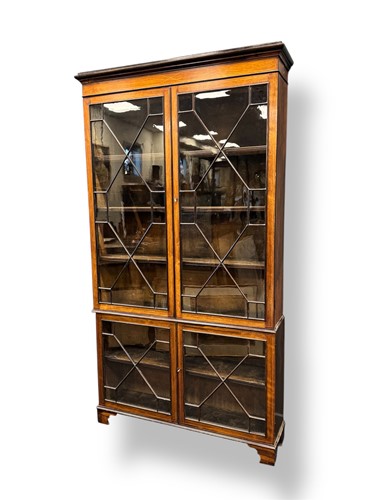 Lot 603 - A late 19th century glazed bookcase in two...
