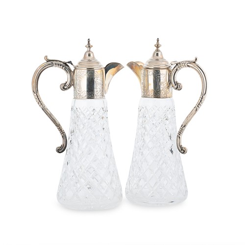 Lot 562 - A pair of Elizabeth II silver mounted glass claret jugs, mark of Garrard & Company